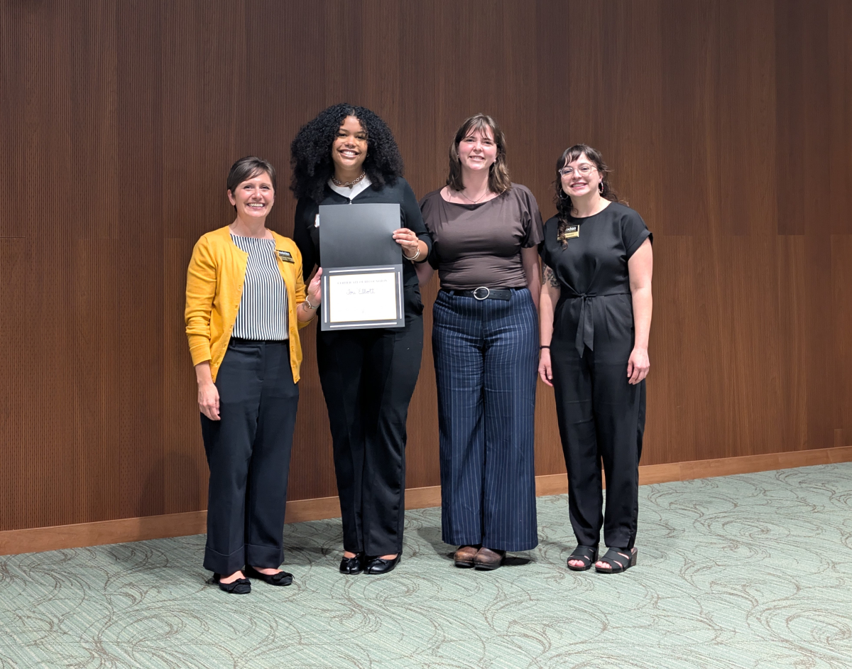 PsyD doctoral students Tori Elliott and Shelby Holmes pictured during the awards ceremony with conference directors Dr. Brook Harmon and Dr. Dani Nunnery of the Department of Nutrition and Health Care Management.