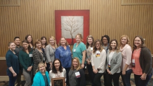 Amy Lowder with award and colleagues