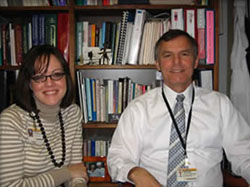 higlighted alumni seated in front of a bookshelf