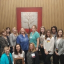 Amy Lowder with award and colleagues