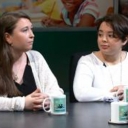 Two women sitting at a table talking