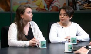 Two women sitting at a table talking